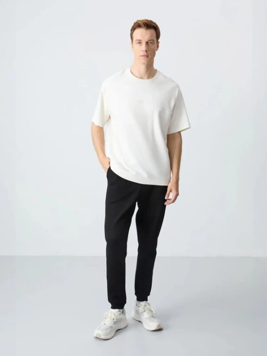 Foto van product Tommy Life Joggingpak ecru / zwart